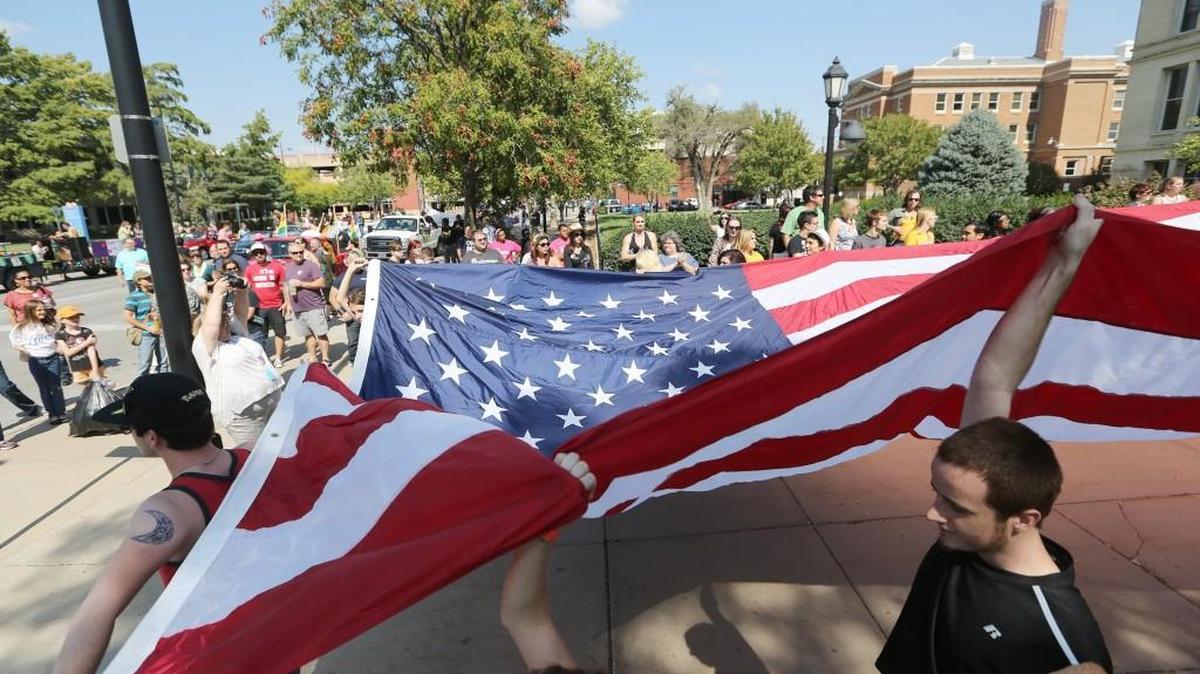 
People carry a large American flag from the Wichita Pride Parade's starting line at the Old Sedgwick County Courthouse last September.

