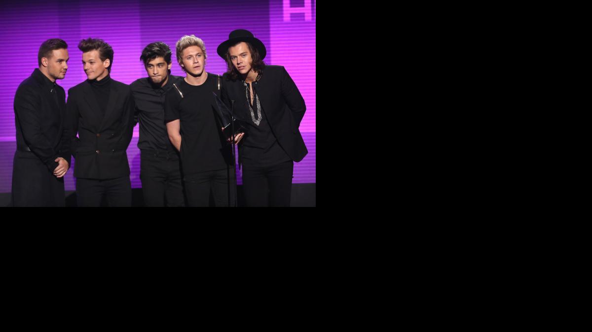 
From left, Liam Payne, Louis Tomlinson, Zayn Malik, Niall Horan and Harry Styles of the musical group One Direction accept the award for favorite pop/rock album for “Midnight Memories” Sunday at the 42nd annual American Music Awards. 
