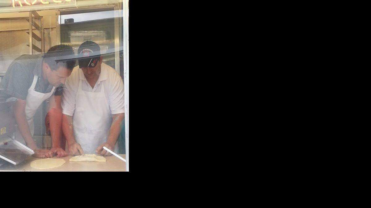 
Sean Price demonstrates how to make elephant ears for Noah Cappe, the host of “Carnival Eats” on the Cooking Channel.
