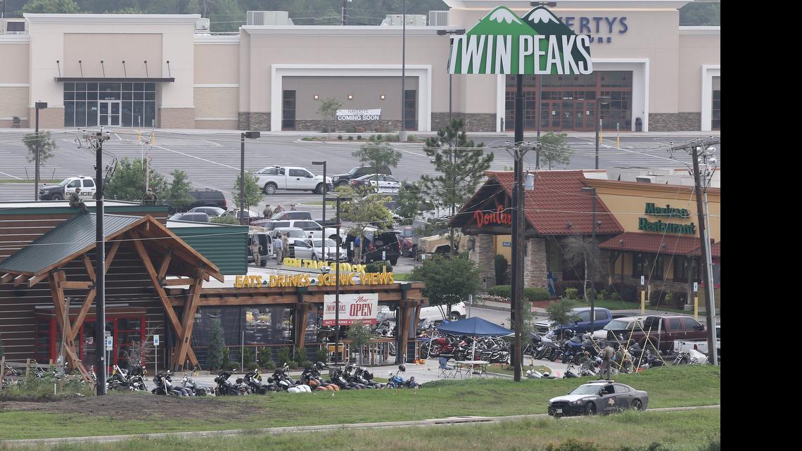 
Law enforcement continue to investigate the motorcycle gang related shooting at the Twin Peaks restaurant, Monday, May 18, 2015, in Waco, Texas, where 9 were killed Sunday and more than a dozen injured. Waco police on Monday announced the Texas Alcoholic Beverage Commission closed Twin Peaks for a week amid safety concerns. 
