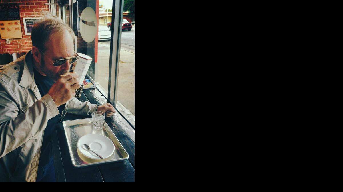 
Alton Brown sips coffee in Reverie Coffee Roasters during his two-day tour of Wichita.
