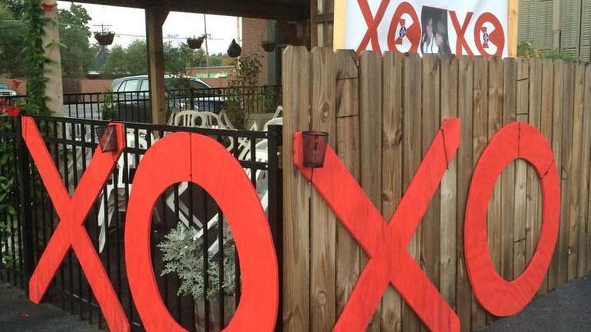 
Giant red X’s and O’s are posted outside Tanya’s Soup Kitchen and The Donut Whole, two businesses at Douglas and Hydraulic. Their creators want people to sign them with messages of love for the businesses late owners.
