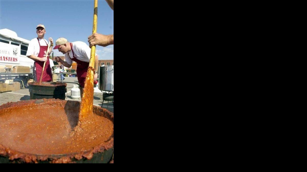 
Members of the Wichita Wagonmasters prepare a vat of chili at the festival.
