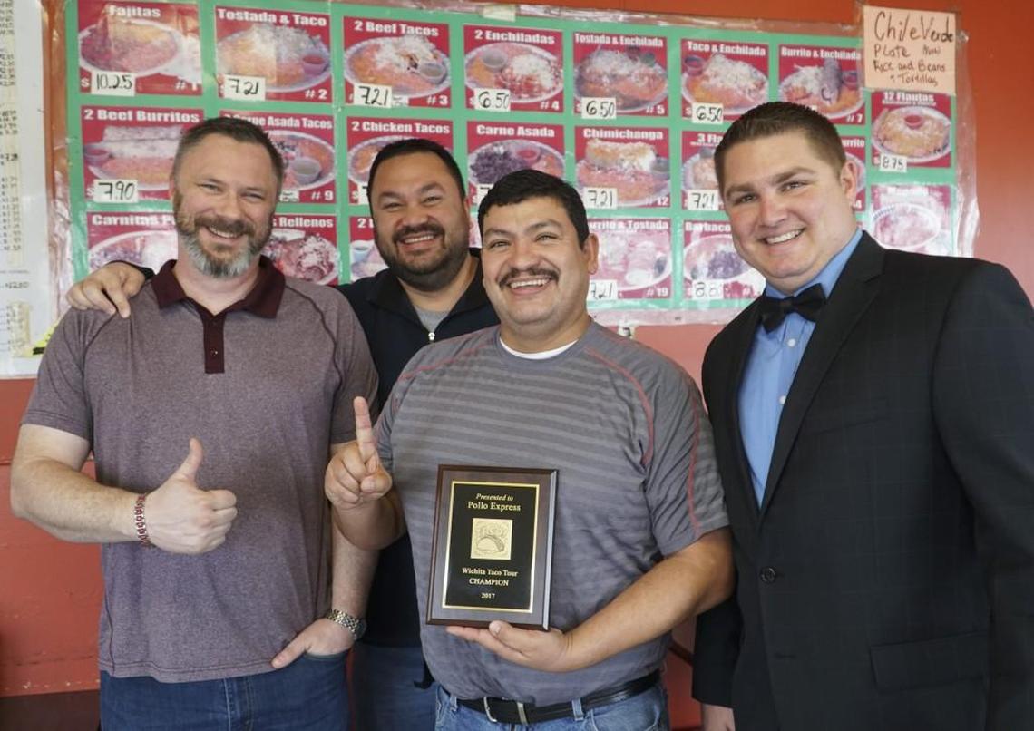 Members of the Wichita Taco Tour, left to right, Travis Hettenbach, Shon Chapman and Chris Kurth, far right, awarded a plaque to Pollo Express owner Ernesto Naranjo in 2018. The group proclaimed Pollo Express the best taco maker in Wichita.
