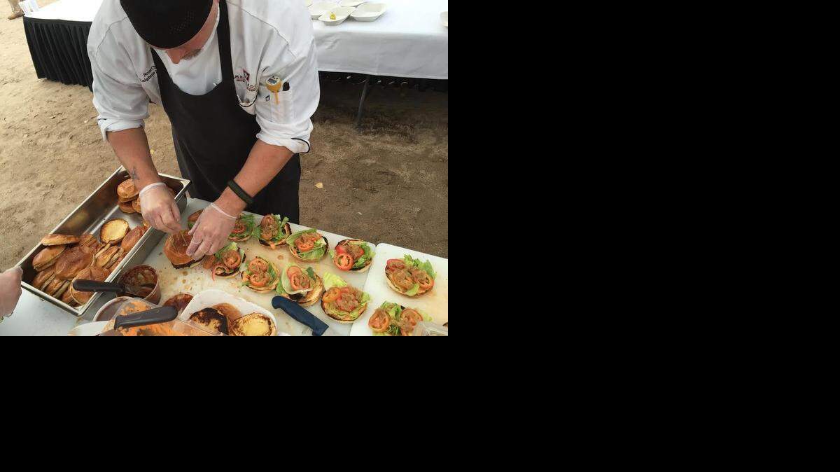 
Siena Tuscan Steakhouse’s sous chef Leighton Merlau prepares burgers for the masses. The restaurant won the best gourmet burger award.
