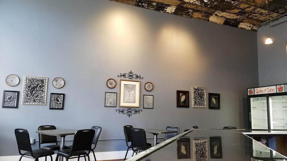The interior of the Garden of Eatin’ restaurant is decorated in pale blue, black and wood tones.
