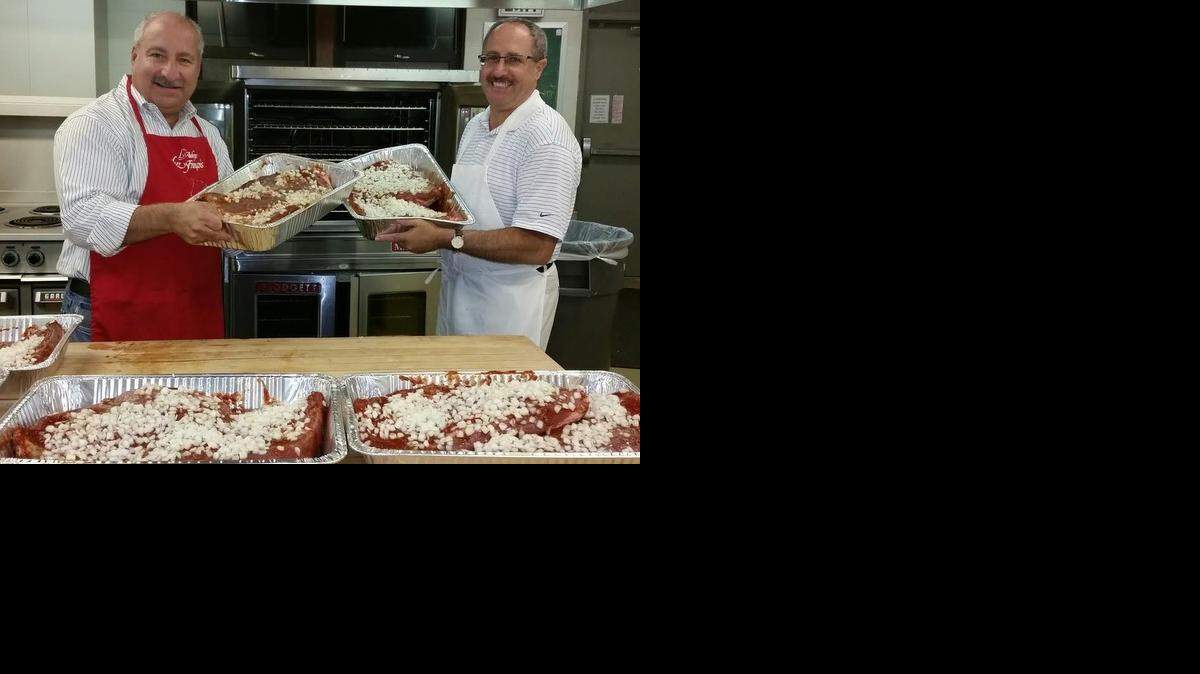 
Scott Redler, left, co-founder of Freddy’s Frozen Custard, and Les Padzensky, vice president of food and beverage for Warren Theatres, help lead the brisket-cooking team for Deli Day at Congregation Emanu-El.
