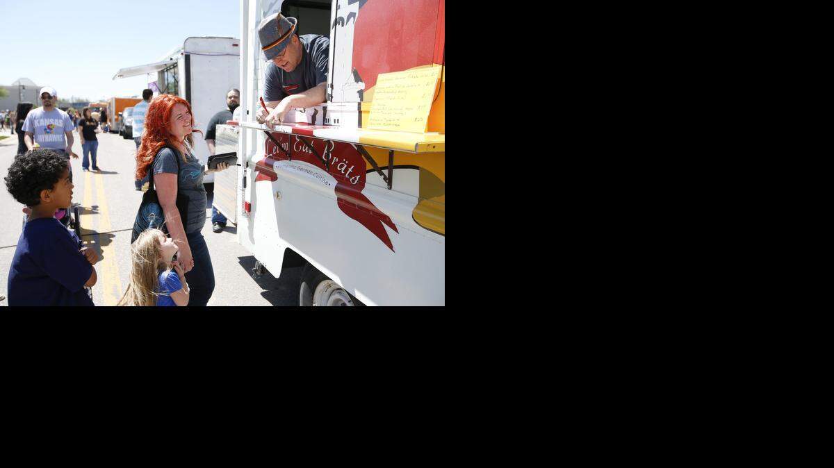 
Austin English takes an order at the Let'm Eat Brats food truck, which will be at Sunday’s rally.
