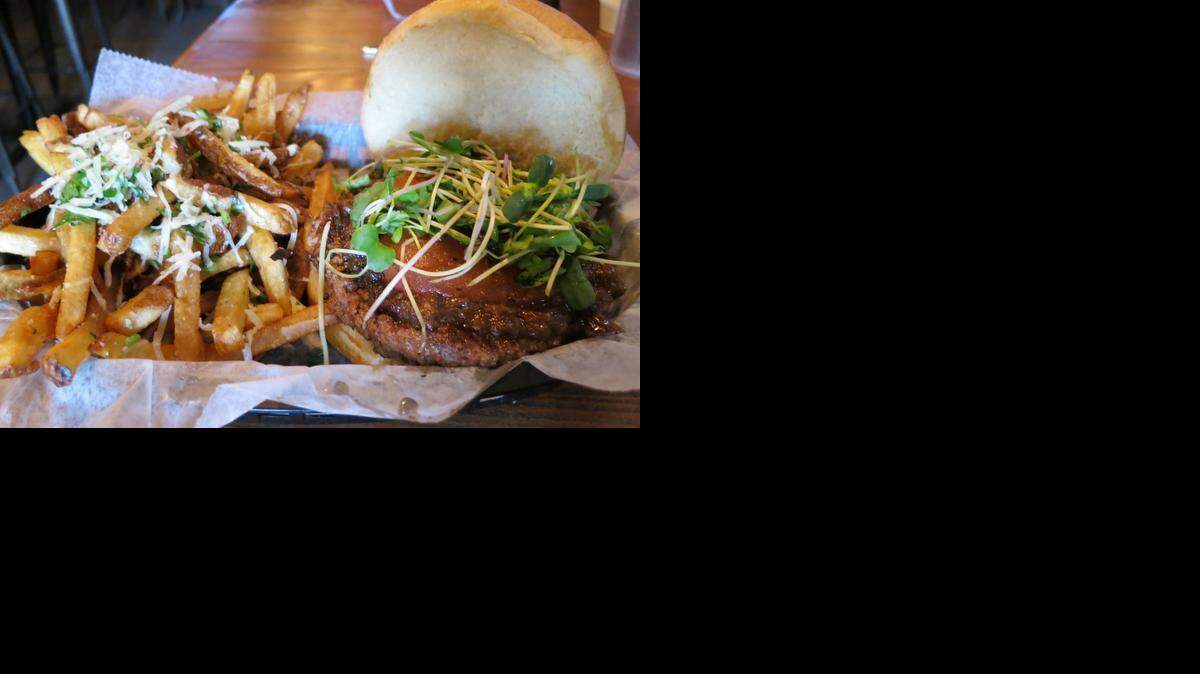 
The “Kobe” burger at Dempsey’s is topped with shallot marmalade, tomato confit and fresh watercress. A side of truffle fries topped with Parmesan cheese and parsley tops off a tasty meal.
