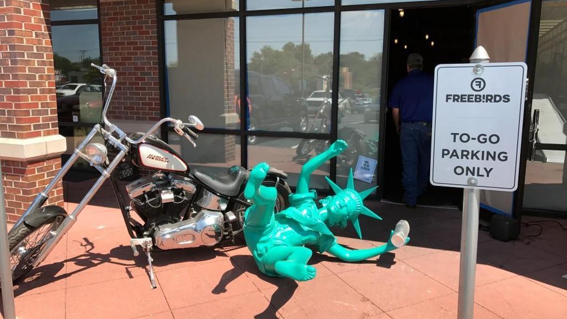 Don’t forget me! A burrito-clutching Statue of Liberty waits to be loaded on the moving truck outside of Freebirds World Burritos at Central and Hillside.