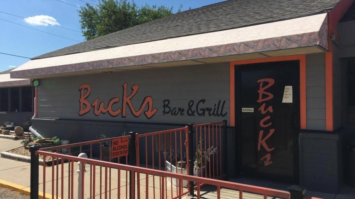A sign on the door at Bucks Bar & Grill says it is closed.