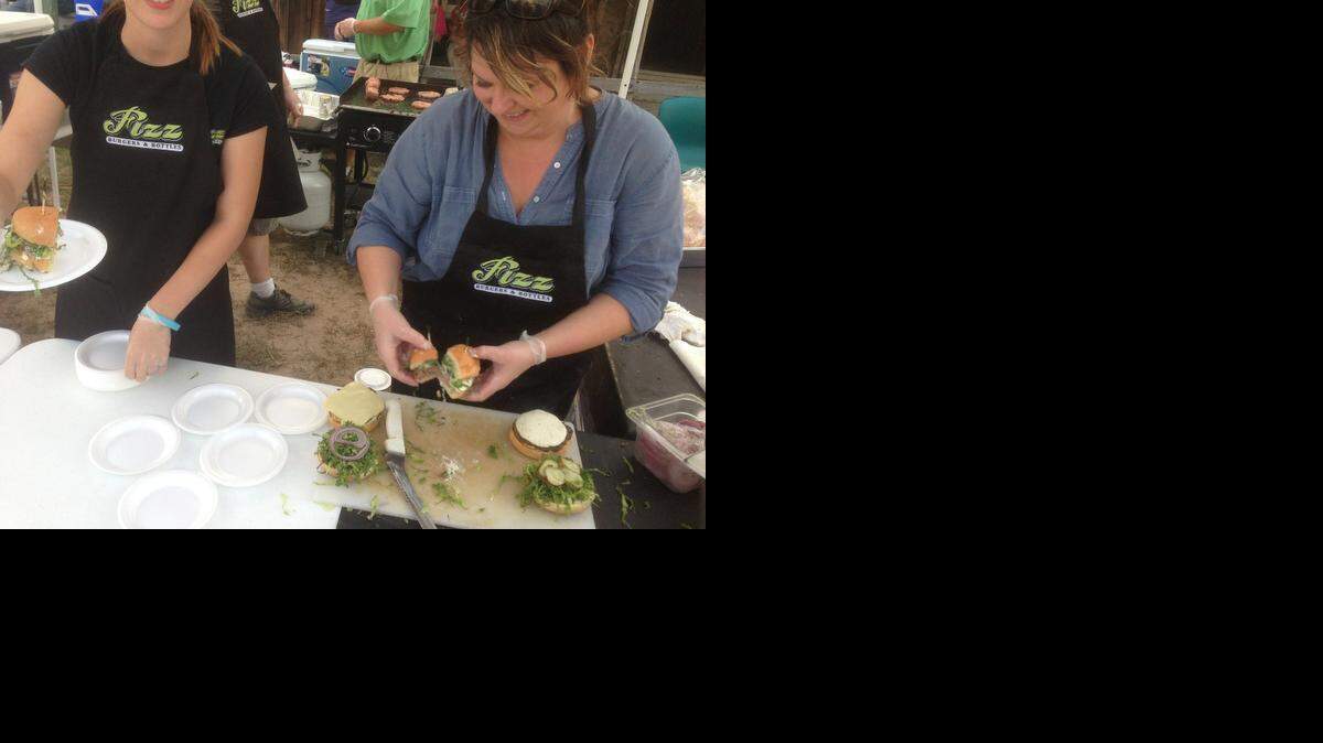 
Employees from Fizz Burgers & Bottles prepare burgers at laste year’s Battle of the Burgers. Fizz won best traditional burger and the People’s Choice trophy.
