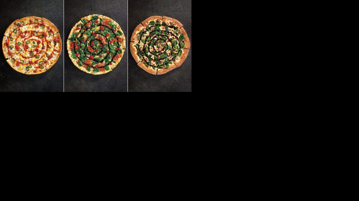 
This combination made with product images provided by Pizza Hut shows the restaurant chain's new specialty pizzas, from left, Sweet Sriracha Dynamite, Cherry Pepper Bombshell, and Pretzel Piggy. The atypical flavors and new ingredients are part of a menu overhaul set to be announced Monday, Nov. 10, 2014 and hit stores Nov. 19.
