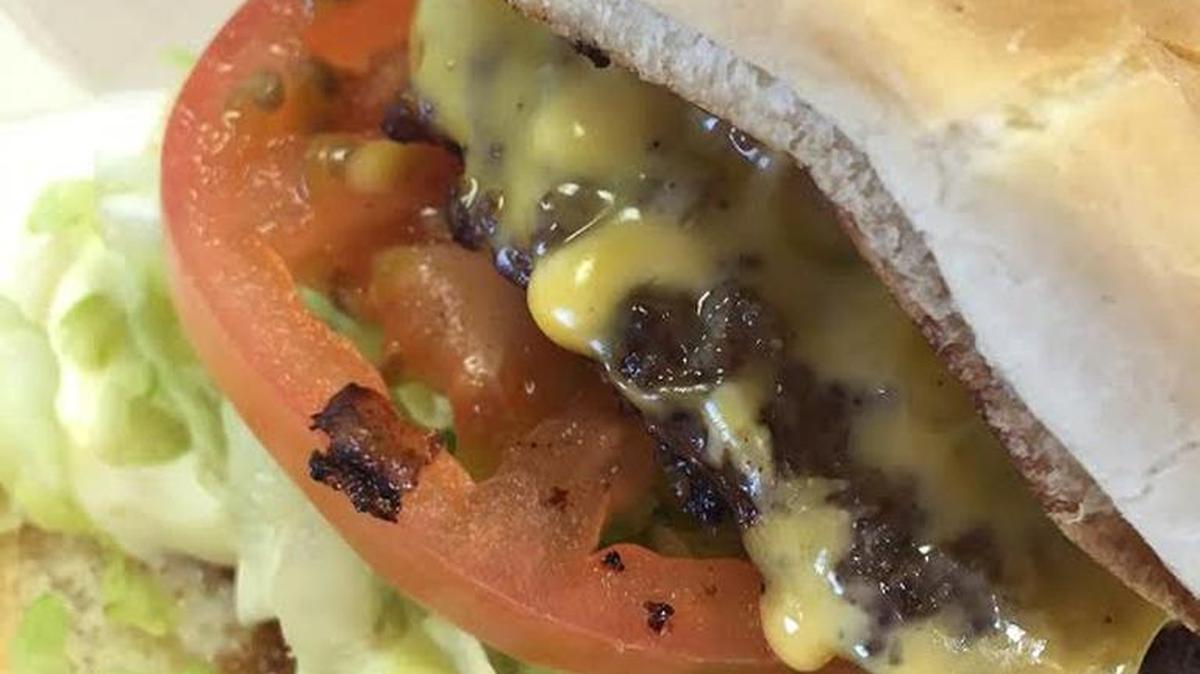 Big Larry’s Burger owner Larry Hall prepares his flat-top burgers to a crispy, cheese-oozing perfection.