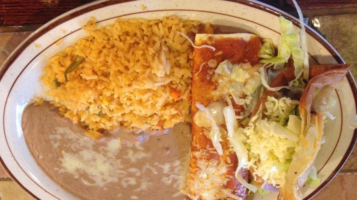A combo meal from Tequila’s in Valley Center, featuring a puffy taco and a chicken enchilada.
