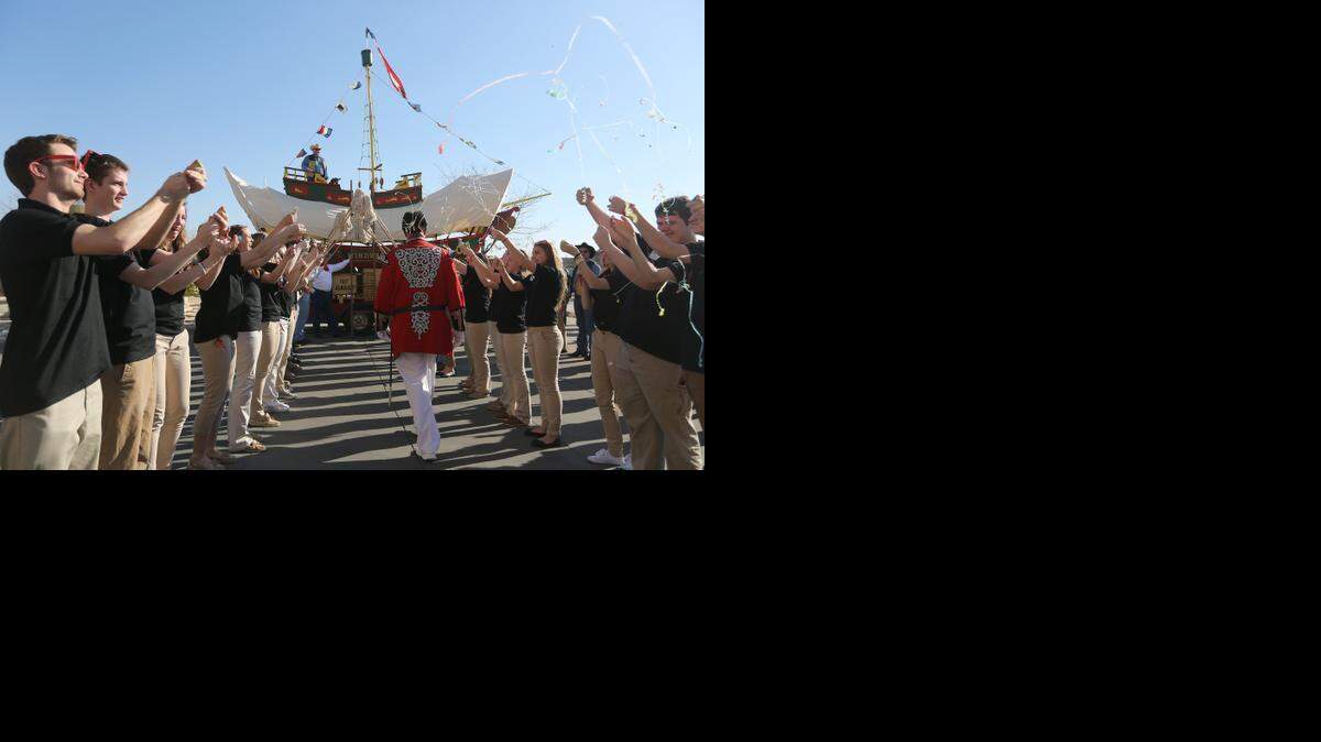 
Admiral Windwagon Smith Mike Greene boards the Windwagon in front of the Hyatt on Thursday. Lining the path are the Schoonermates and Wichita Wagonmasters. (March 12, 2015)
