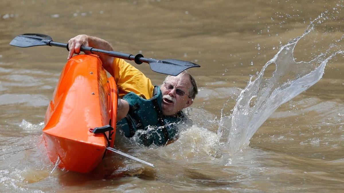 Lee Fletcher capsizes his kayak during the start of the kayak races on the Arkansas River on the final day of the Wichita River Festival in 2015.
