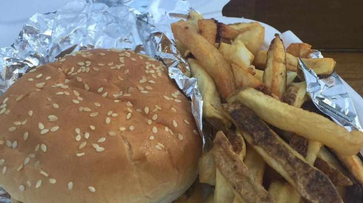 The monster burger is a bacon cheeseburger with mac ’n’ cheese on top.