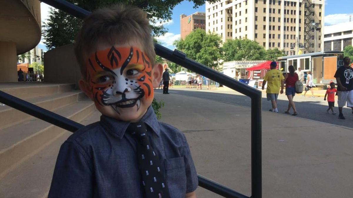 Cruz Baltazar Garcia, 3, of Wichita shows off his tiger face paint Saturday at Riverfest in downtown Wichita. (June 4, 2016)