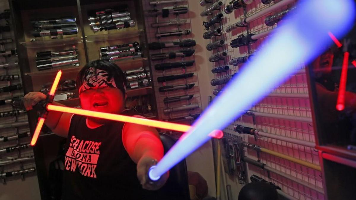 Tsai Jung-chou, also known as “Makoto Tsai,” poses with his handcrafted replicas of the “Star Wars” lightsaber at his home workshop in New Taipei City, Taiwan. A former optical engineer, Tsai now designs and fabricates his own versions of the iconic sci-fi weapon, which he sells for up to $400 per model.