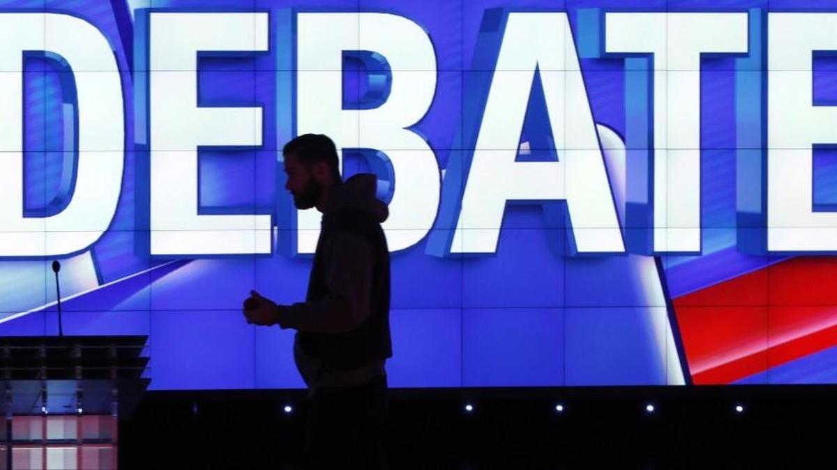 A production staffer walks across the debate stage before the CNN Republican presidential debate at the Venetian Hotel & Casino in Las Vegas last year.
