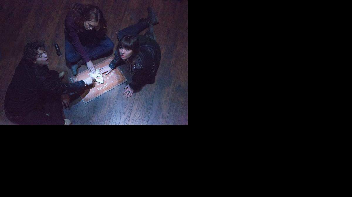 
This photo provided by Universal Pictures shows, from left, Douglas Smith, as Pete, Olivia Cooke, as Laine, and Ana Coto, as Sarah, in the film, “Ouija.
