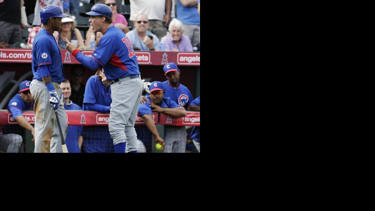 
Actor Will Ferrell, acting as the third base coach, talks to Chicago Cubs' Addison Russell during the team's spring training baseball game against the Los Angeles Angels in Tempe, Ariz., on Thursday, March 12, 2015. (AP Photo/Chris Carlson) 
