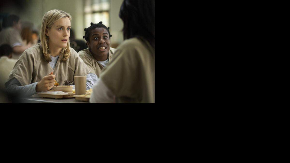 
This image released by Netflix shows Taylor Schilling, left, and Uzo Aduba in a scene from “Orange Is the New Black.”
