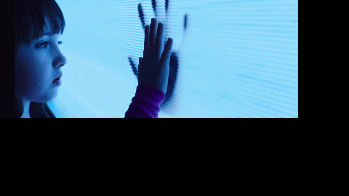 
Maddy (Kennedi Clements) reaches out to apparitions that have invaded her family’s home in “Poltergeist.” 
