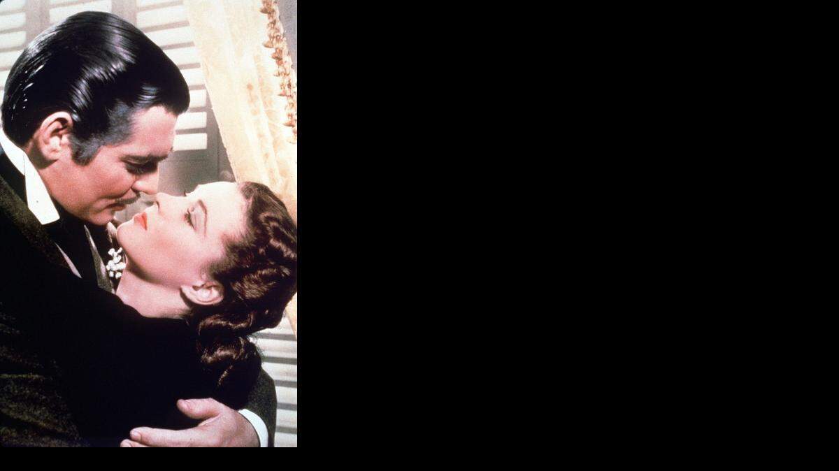 
Rhett Butler (Clark Gable) embraces Scarlett O’Hara (Vivien Leigh) during a scene from “Gone With the Wind.” 
