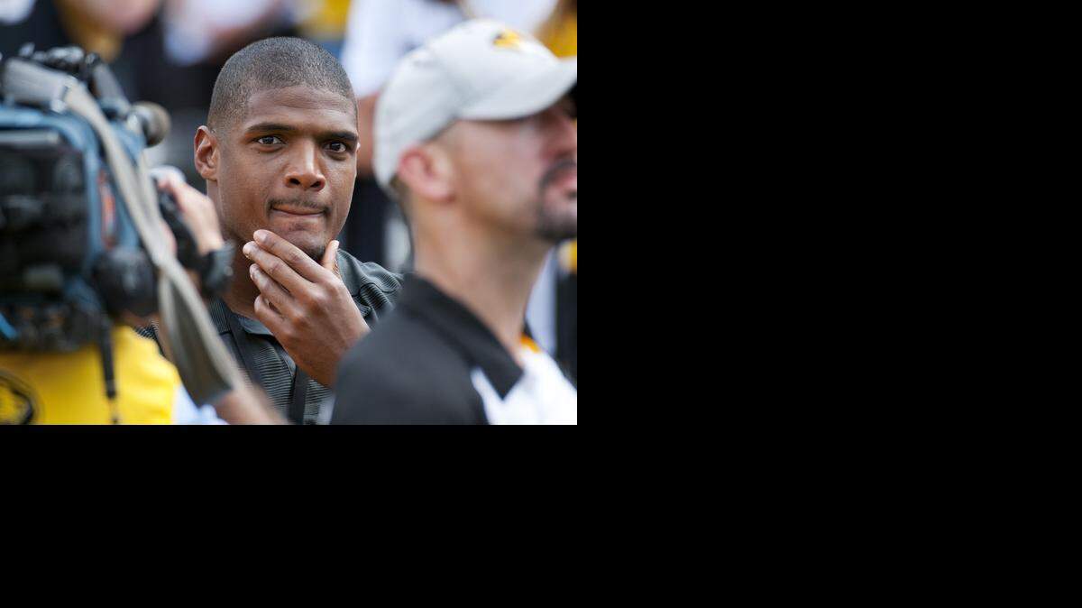 
Former Missouri player Michael Sam watches pregame festivities before the start of the South Dakota State-Missouri NCAA college football game Saturday, Aug. 30, 2014, in Columbia, Mo. Sam, the first openly gay player drafted by an NFL team, was released by St. Louis Rams Saturday. (AP Photo/L.G. Patterson) 
