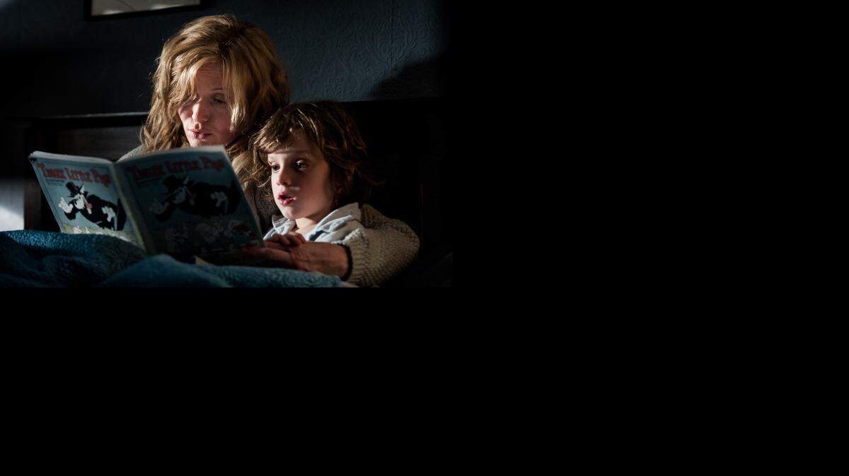 
Amelia (Essie Davis) tries to comfort her son, Sam (Noah Wiseman), with a bedtime story that becomes a nightmare in “The Babadook.”
