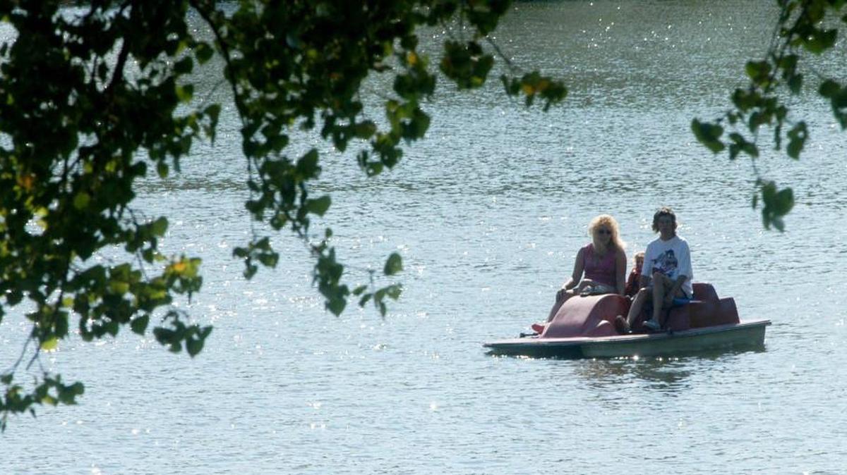 People take a ride on a paddle boat at O.J. Watson park.