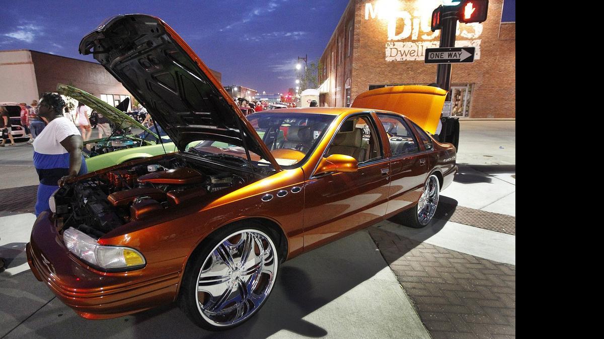 
Spectators check out 1995 Chevy Caprice at Automobilia in 2013.

