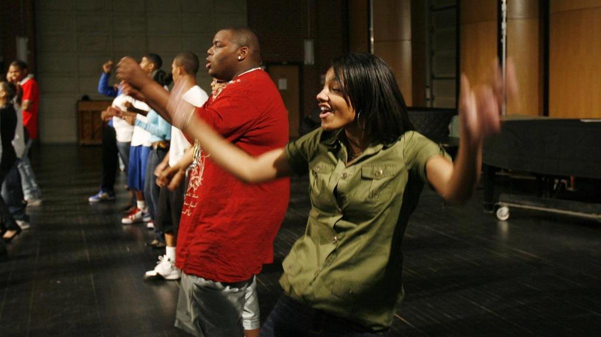 People rehearse for Beautillion 2009 on a stage at Wichita State University.