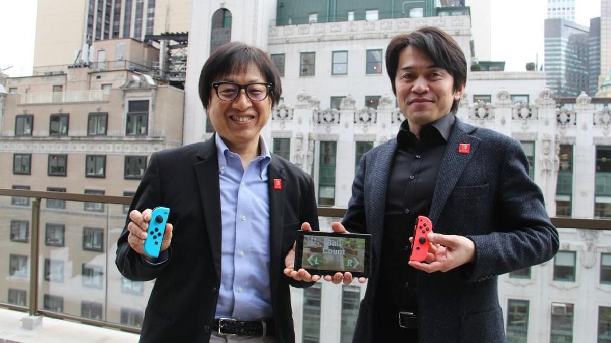 Nintendo managing executive director Shinya Takahashi, left, and Nintendo Switch developer Yoshiaki Koizumi pose with components of the Nintendo Switch gaming system in New York.
