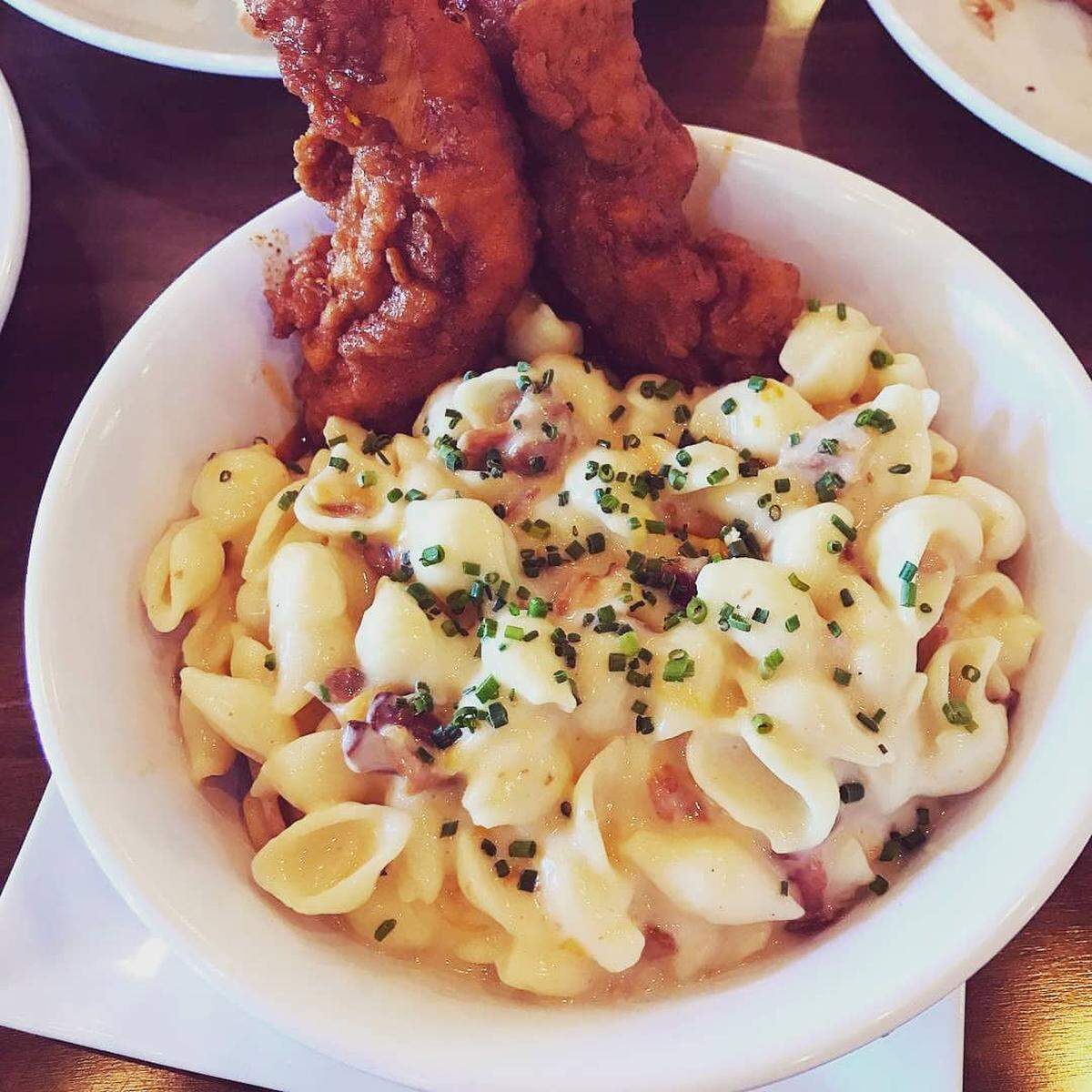 The mac and cheese at Dempsey’s Biscuit Co. comes topped with chicken tenders.