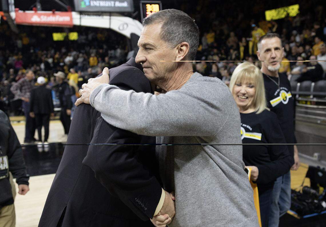 Former Wichita State coach Mark Turgeon(right)  gives radio broadcaster Mike Kennedy a hug during halftime of the game against Temple at Koch Arena on Saturday.