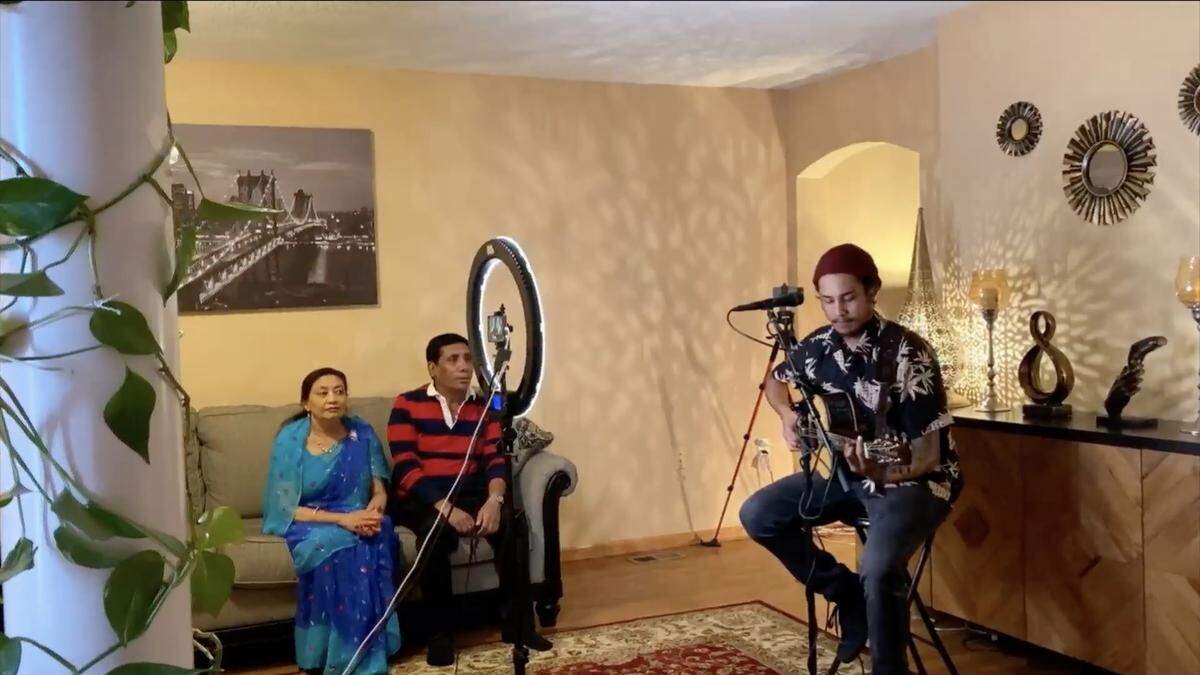 Arthur Gunn performs from his east Wichita home as parents Maiya and Datram watch.