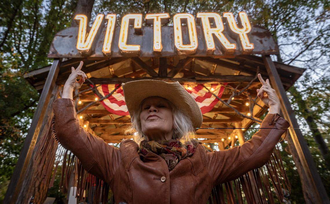 Robin Macy stands in front of one of the signs salvaged from Wichita’s Victory Theatre, which operated from 1939 to 1977 where Naftzger Park is now. Macy recently bought the sign, had it restored and hung it over the performance stage at her Bartlett Arboretum in Belle Plaine.
