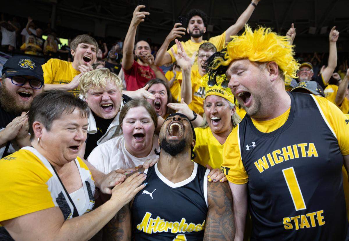 Marcus Keene celebrates with fans after his three pointer gave the Aftershocks the 66-63 win over Forever Coogs in the quarterfinal of the TBT Tournament at Koch Arena on Tuesday night. 