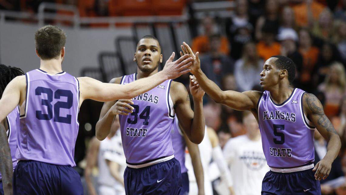Kansas State forward Dean Wade (32), forward Levi Stockard III (34) and guard Barry Brown (5) celebrate as they walk off the court during a timeout in the second half of an NCAA college basketball game against Oklahoma State in Stillwater, Okla., on Wednesday, Feb. 14, 2018.