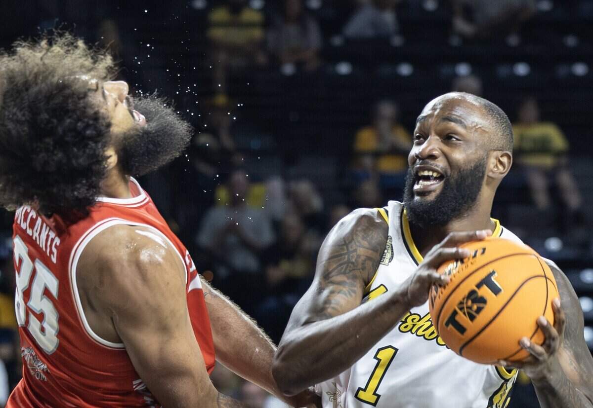 Markis McDuffie collides with The Enchantments' Johnny McCants during the first half of their second game of the TBT tournament at Koch Arena on Thursday night.