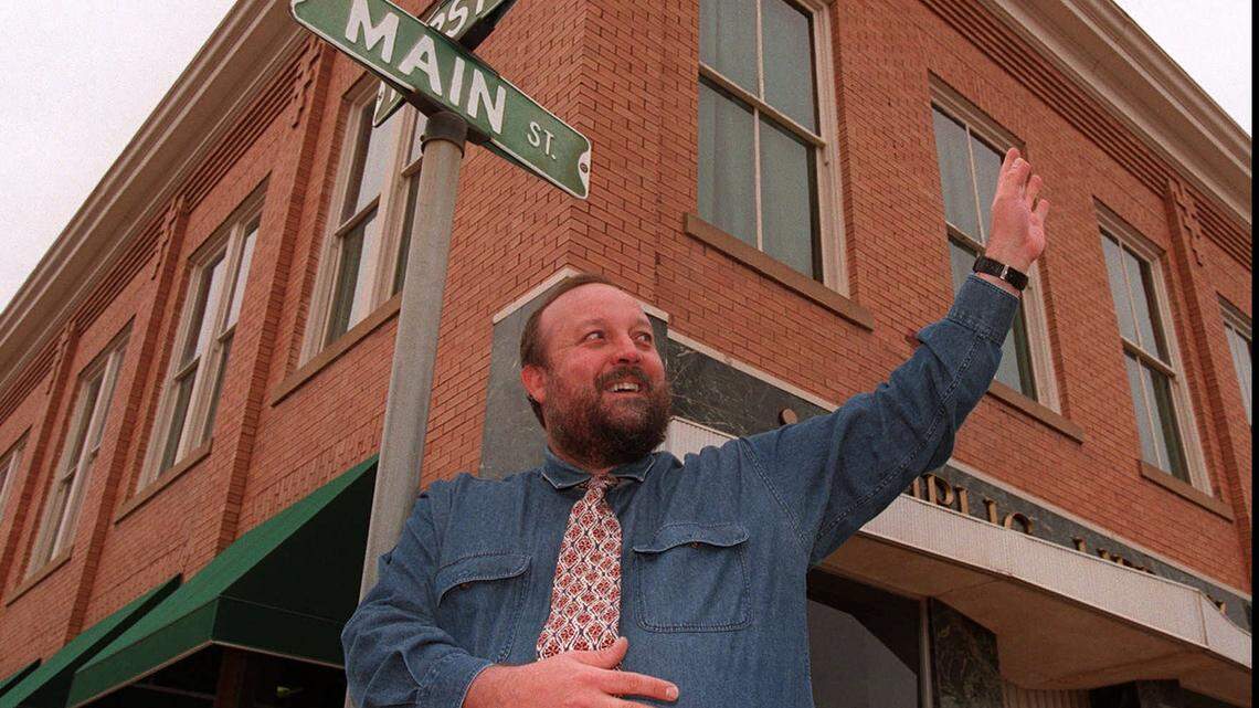Cheney Mayor Carl Koster waves to a passerby at First and Main in downtown Cheney in 1999.