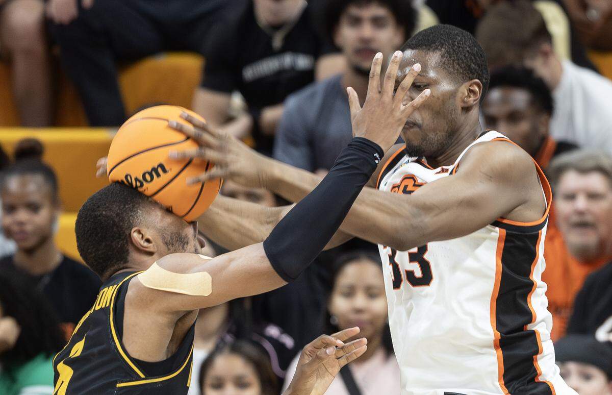 Wichita State’s Corey Washington has the ball bounced off his face late in the game by Oklahoma State’s Abou Ousmane during their first round NIT game in Stillwater, Ok., on Tuesday night.