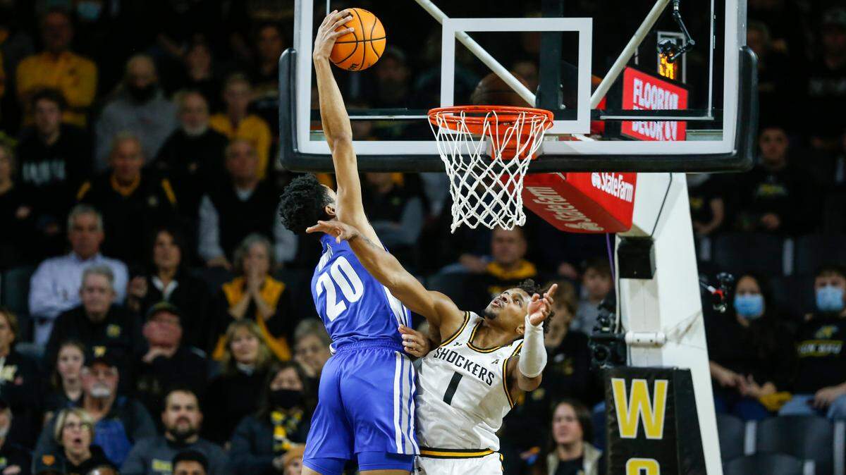 Memphis’ Josh Minott dunks over Wichita State’s Tyson Etienne during the first half on Saturday morning at Koch Arena.