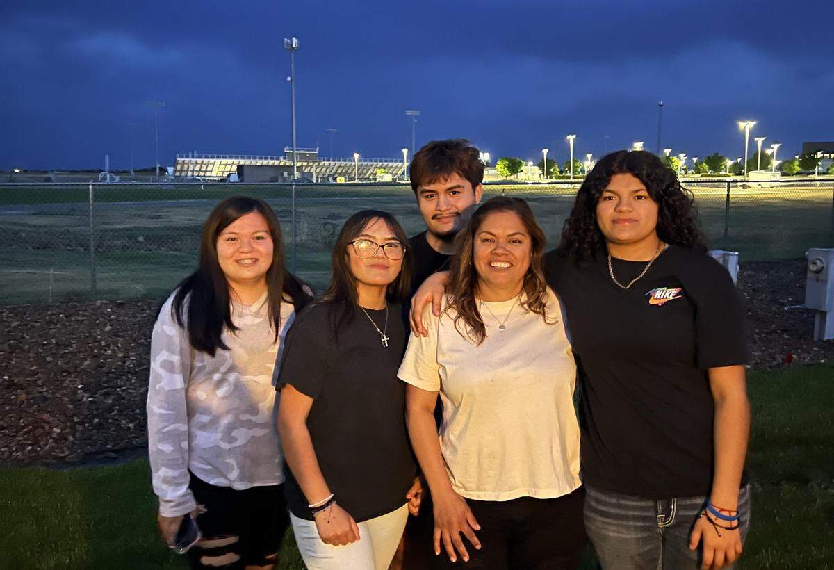 Emiliano Urbina (back center), 19, of Garden City poses for a photo with his younger sister and their aunt. Urbina was injured Saturday in a home explosion. He remained hospitalized Tuesday.