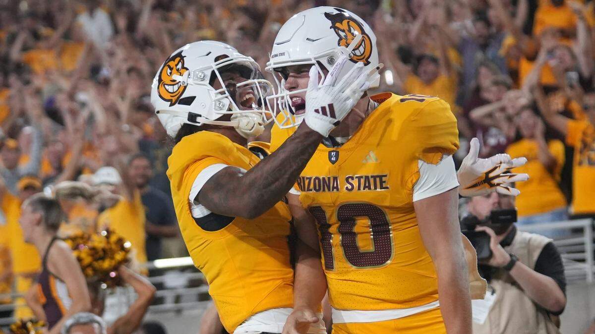 ASU Sun Devils quarterback Sam Leavitt (10) celebrates his touchdown run with teammate Jordyn Tyson (0) against the Mississippi State Bulldogs at Mountain America Stadium in Tempe on Sept. 7, 2024.