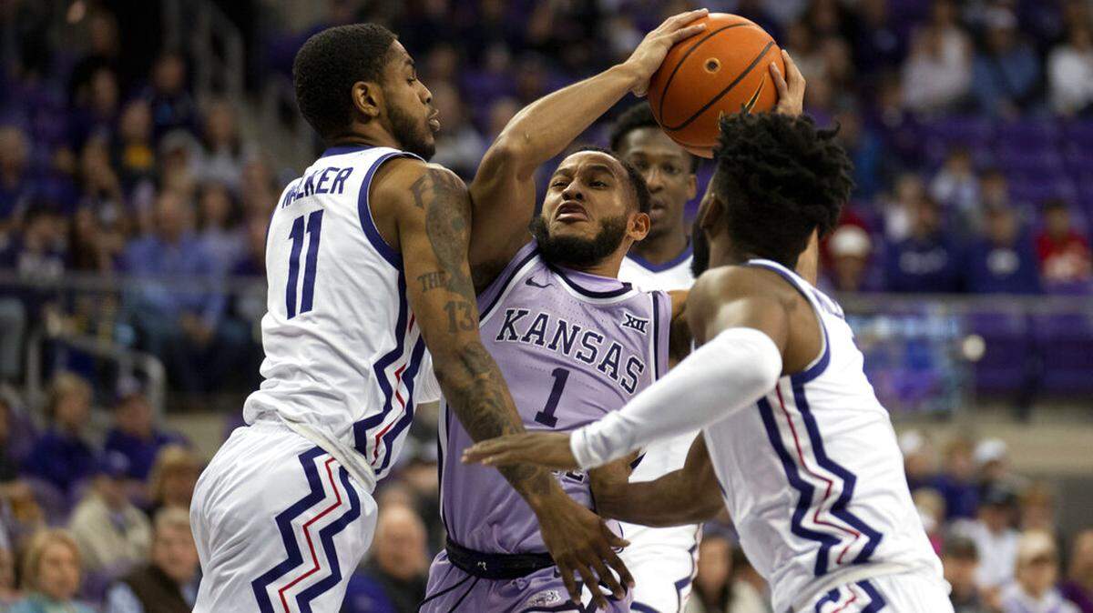 Kansas State guard Markquis Nowell (1) drives to the basket between TCU’s Rondel Walker (11) and Mike Miles Jr., right, in the first half of an NCAA college basketball game in Fort Worth, Texas, Saturday, Jan. 14, 2023. (AP Photo/Tony Gutierrez)