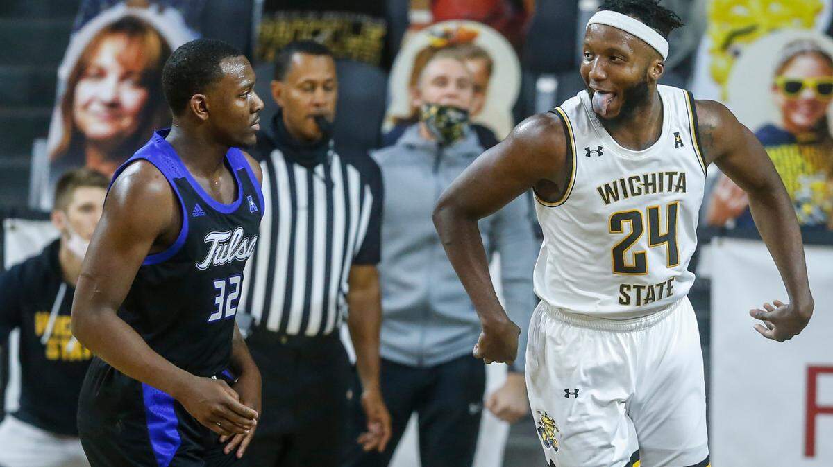 Wichita State’s Morris Udeze sticks his tongue out at Tulsa’s Austin Richie after hitting a shot in the second half against Tulsa at Koch Arena on Wednesday.